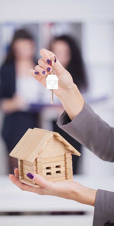 real-estate-agent-giving-house-keys-to-a-customers