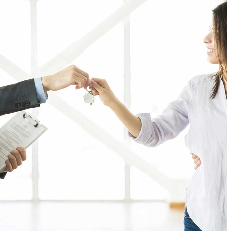 real-estate-agent-handing-keys-to-couple-in-new-applicant